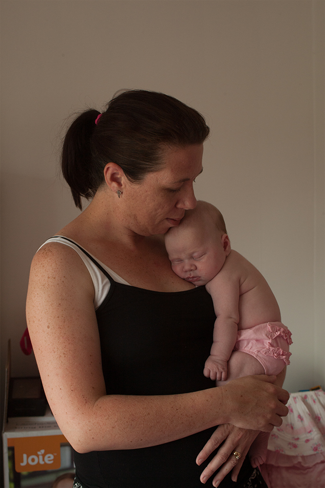 Portrait of an adult holding a baby close, ideal for showcasing professional photo restoration services for family moments.