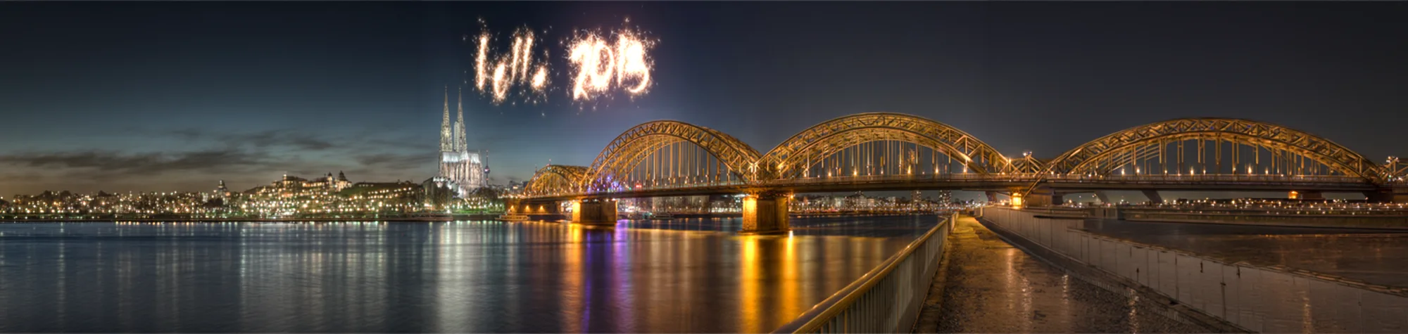 A wide panoramic banner showing the word "CELEBRATE" transformed into a vibrant firework display with sparks, light trails, and a glowing neon effect in Photoshop.
