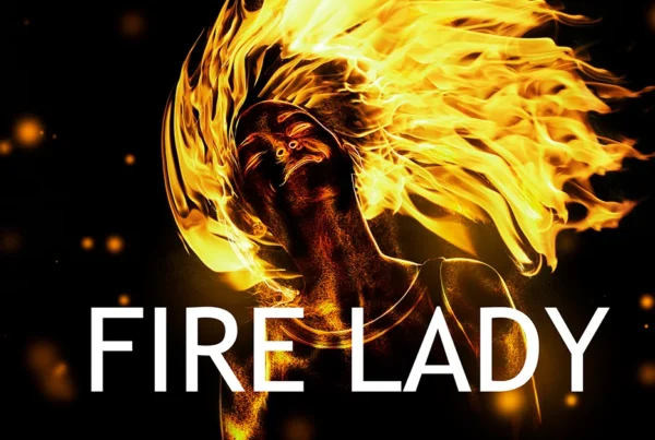 A thumbnail for a Photoshop tutorial showing a woman with hair made of roaring flames, surrounded by glowing embers and sparks against a dark background with text "Fire Lady" at the bottom.