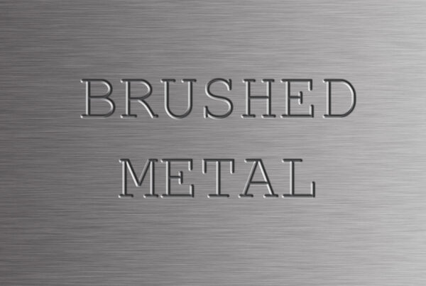 Photoshop tutorial thumbnail featuring the text "Metal FX" embossed on a dark, brushed titanium background with realistic light glints on the edges.
