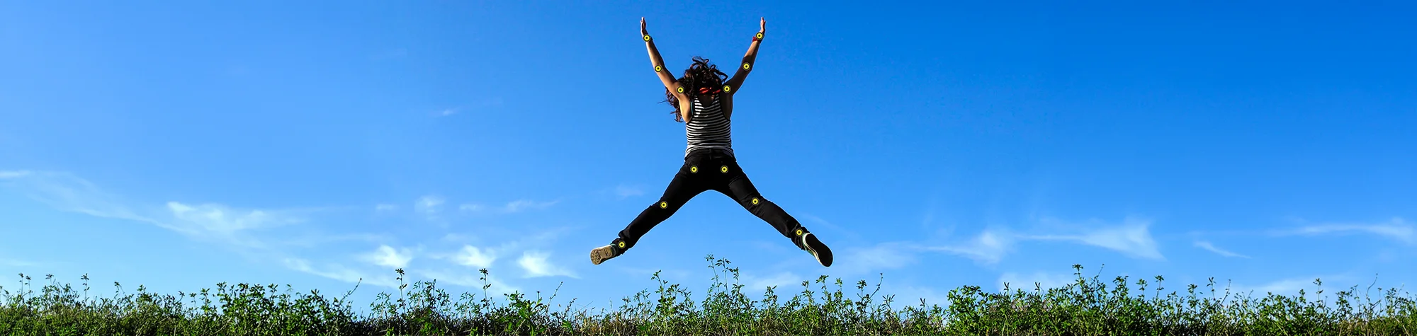 A wide panoramic banner showing an athlete in mid-air where their pose is being subtly adjusted using the Puppet Warp mesh and pins for a more dynamic composition.