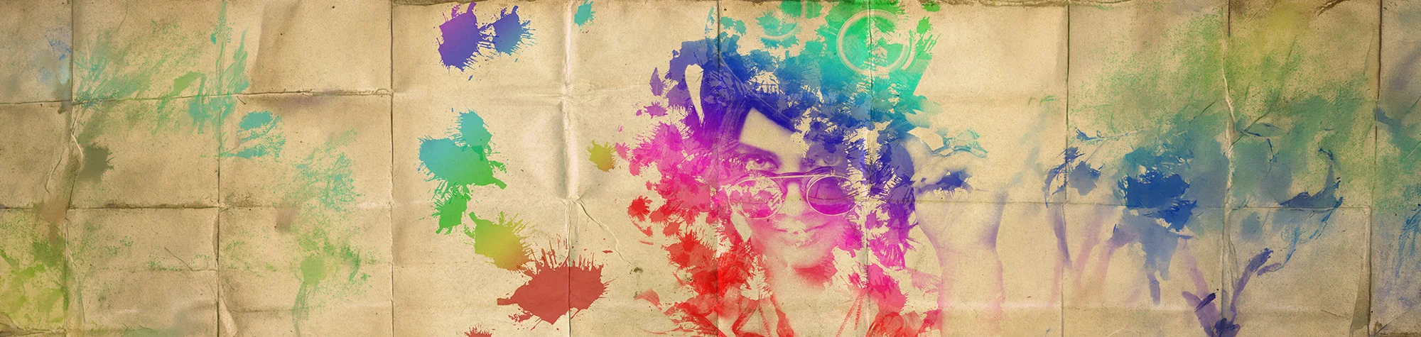 A wide panoramic banner featuring a woman's portrait blended with a vibrant watercolour effect and splatters on a vintage paper texture in Photoshop.
