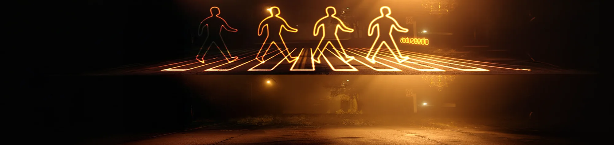 A wide panoramic banner showing a long-exposure city street where vibrant, glowing blue and orange light trails are being digitally "painted" around a central subject using Photoshop.