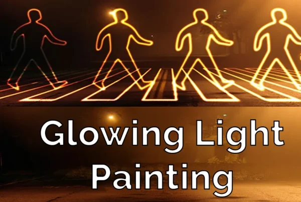 hotoshop tutorial thumbnail featuring the text "Glowing Light Painting" over a dark street with light trails being painted to form people walking across a zebra crossing